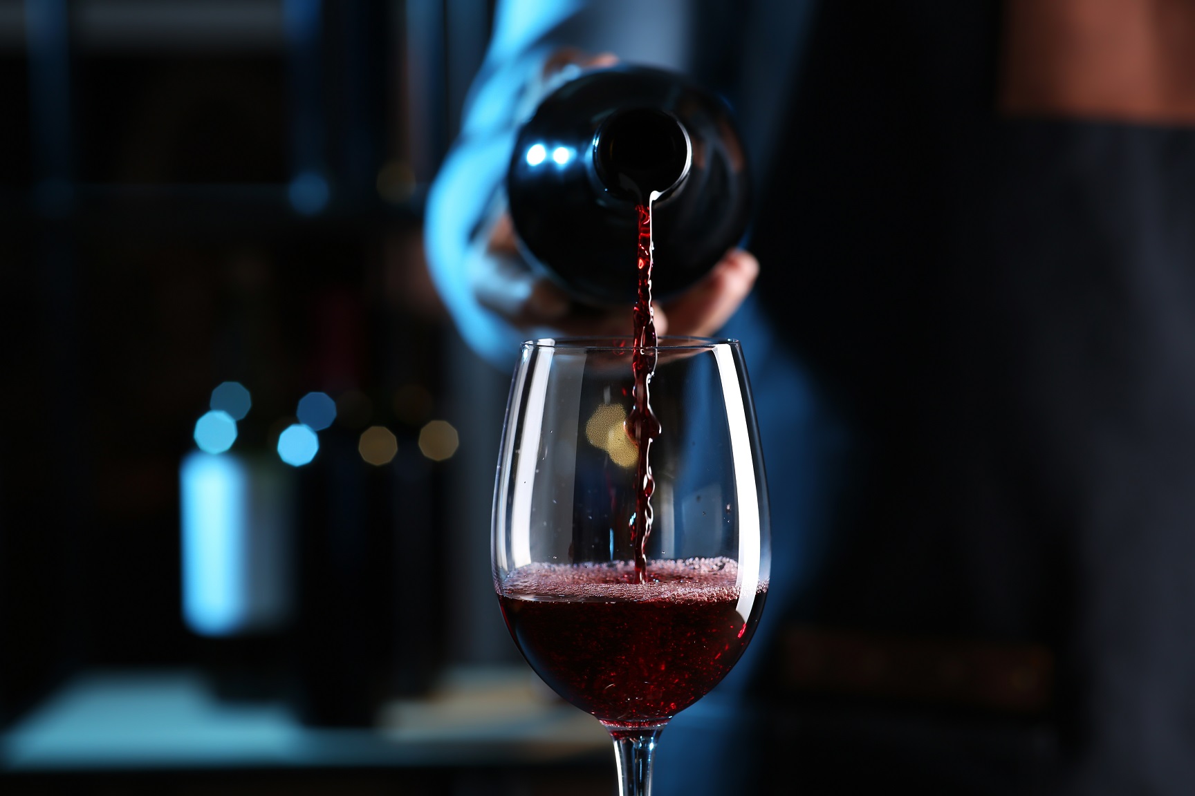 Bartender,Pouring,Red,Wine,From,Bottle,Into,Glass,Indoors,,Closeup
